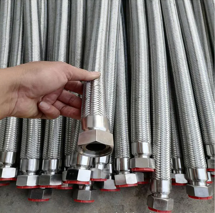 Hand inspecting a stainless steel braided hose with hex-nut end fitting